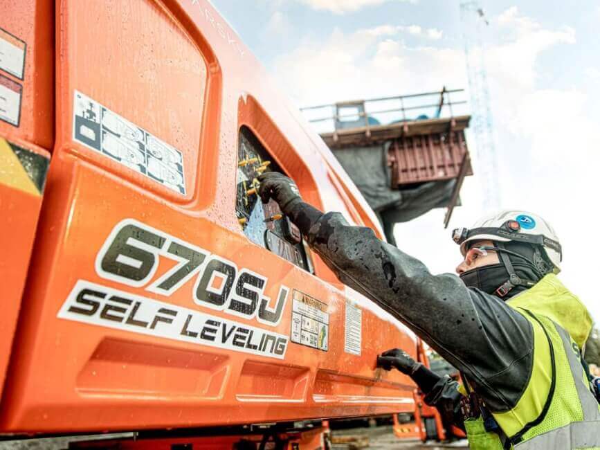 Worker with JLG 670SJ Boom Lift, to represent the Service Department